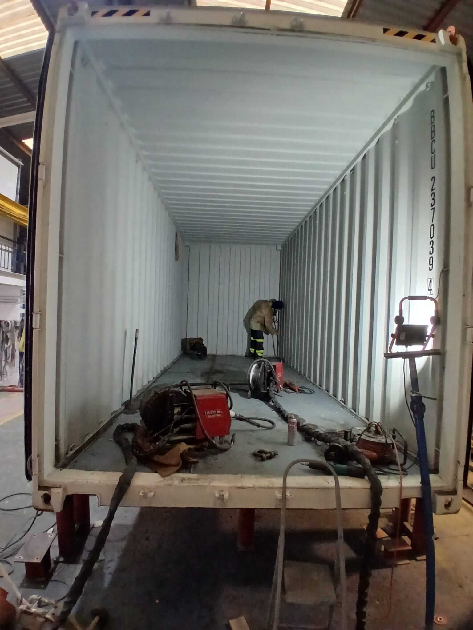 2_ContainerInterior_beginning_2 Worker carrying out structural modifications inside the POSEIDON energy storage container.